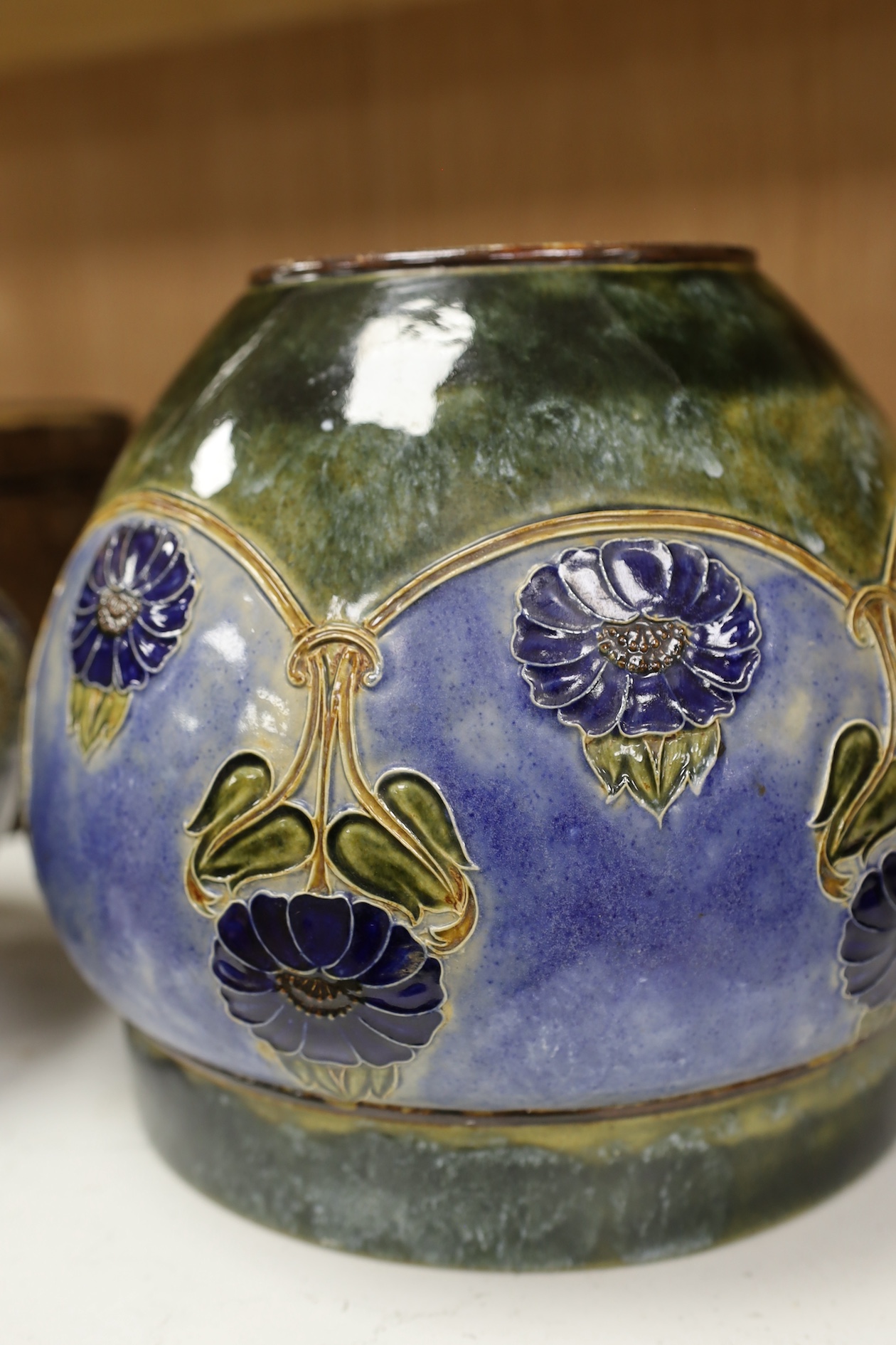 A Royal Doulton blue stoneware jardiniere by Hannah Barlow and another smaller jardiniere by Maude Bowden, largest 29cm in diameter (2). Condition - good